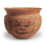 Haji ware: jar with ink drawing of human face.