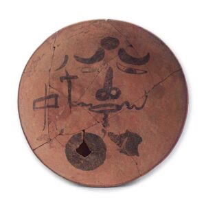 Haji ware dish with ink drawing of human face.