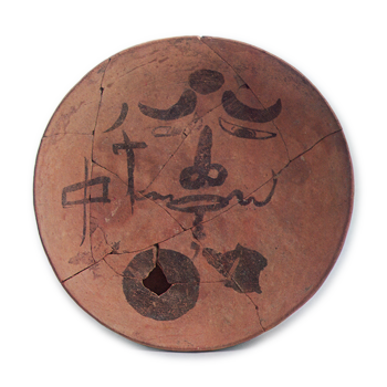 Haji ware dish with ink drawing of human face.
