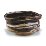 Black Oribe "shoe" shaped tea bowl with horizontal stripe design, known as "Matsu-kaze"