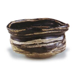 Black Oribe "shoe" shaped tea bowl with horizontal stripe design, known as "Matsu-kaze"