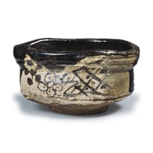 Black Oribe "shoe"-shaped tea bowl with plum blossom design