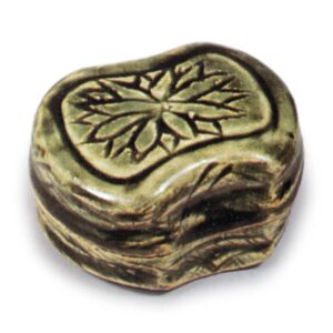 Oribe incense caddy in shape of balance weight with chrysanthemum design