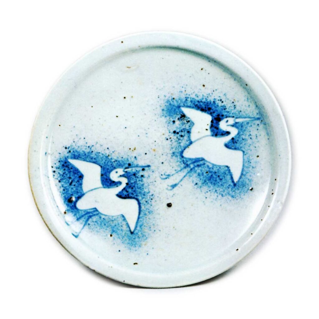 Dish with design of two cranes in flight against "blown ink",