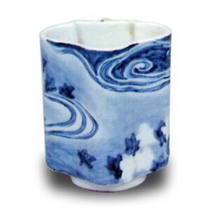 Wine cup with design of maple leaves afloat on water stream. blue