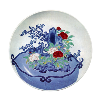 Dish with design of flower pot with peonies and treesaround rocks. enamelled ware