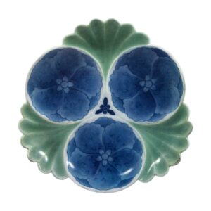 Dish with design of hibiscuses in circles. celadon glaze. andblue and white