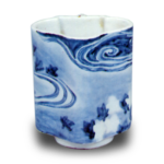 Wine cup with design of maple leaves afloat on water stream. blue