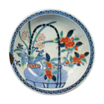 Disn with design of camellias in pots, undergiaze blue, overgiaze enamels