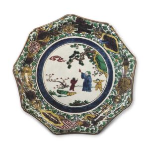 Nonagonal dish with design of Chinese figures on the rocks, enamelled ware