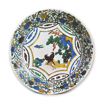 Large dish with design of landscape with two birds surrounded by various flowers, enamelled ware