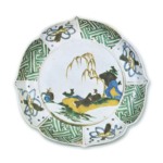 Foliated bowl on foot with design of figure lying under willow tree, enamelled ware