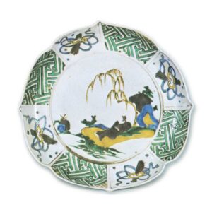 Foliated bowl on foot with design of figure lying under willow tree, enamelled ware