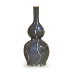 Gourd-shaped wine bottle with gold and silver ornaments over blue glaze